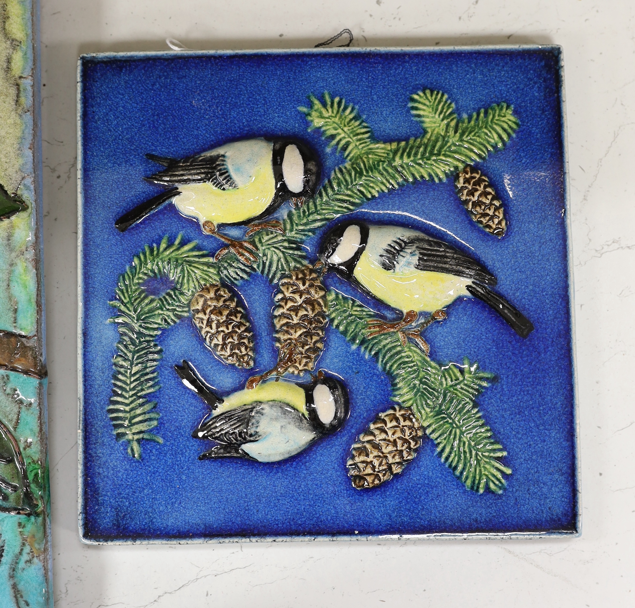 Two West German pottery Karlsruhe Majolika 1960s wall plaques of birds, the larger with budgie, smaller with blue tits, larger plaque 40 x 39.5cm